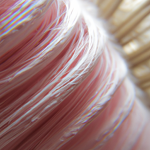 Suggestion: A close-up of a light pink and white swirled brush with a soft glow.