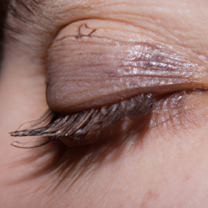 A close-up of an eye with a few flecks of mascara on the eyelashes.