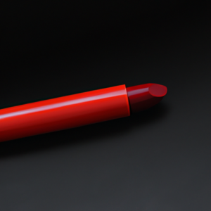 A bright red lip liner with a black background.