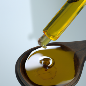 A close-up of a bottle of castor oil with a few drops of oil on a spoon