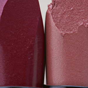 A close-up of two different colored lipsticks blending together.
