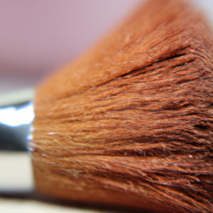 A close up of a natural makeup brush, with a slightly blurred background.