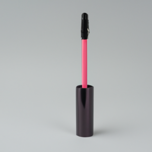 A bright pink tube of mascara against a light gray background.