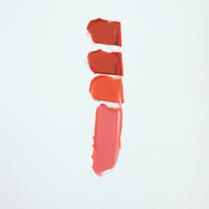 A swatch of lipstick in shades of pink and coral on a white background.