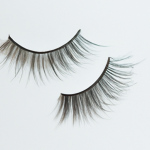A close-up of a pair of false eyelashes, with the tips of the lashes slightly curled up.