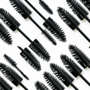 A close-up of a set of mascara brushes in a fan pattern against a white background.